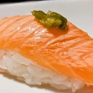 a piece of sushi on a white plate