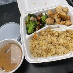 rice, broccoli, and chicken in a styrofoam container