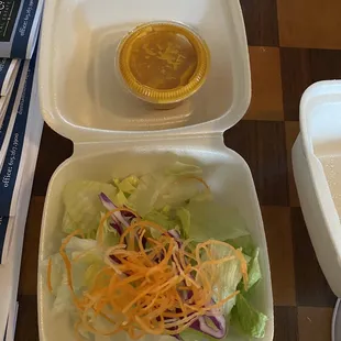 The side salad with old and clumpy dressing.