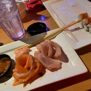a plate of sushi and chopsticks
