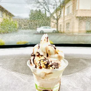 a cup of ice cream with toppings