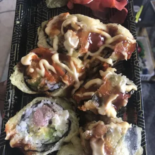 a person holding a plate of sushi