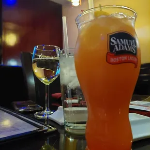 a glass of orange juice and a glass of white wine