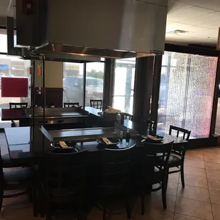 a kitchen with a large table and chairs