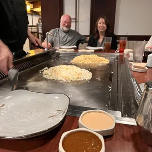 a chef preparing food on a grill