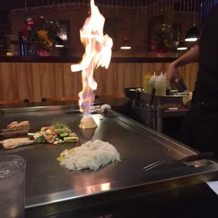 a man preparing food on a grill