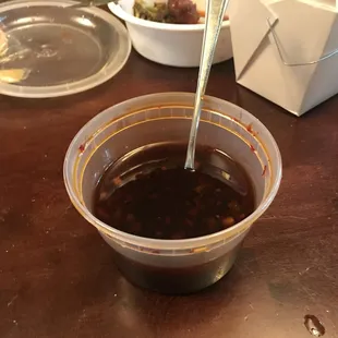 a bowl of sauce with a spoon