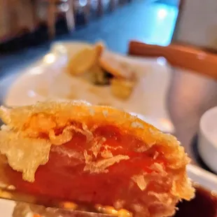 a piece of sushi on a fork