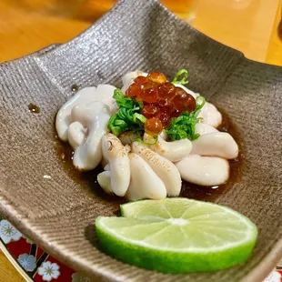 a plate of squid and lime slices