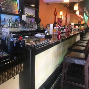 a view of a bar with stools