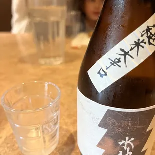a bottle of sake and a shot glass