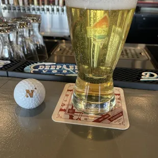 An excellent Pilsner, New Trail Lazy River Pils.  And a golf ball from the adjacent course that flew by on the way in to lunch.