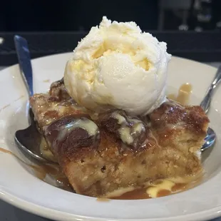 Bread pudding with a scope of Vanilla ice cream.