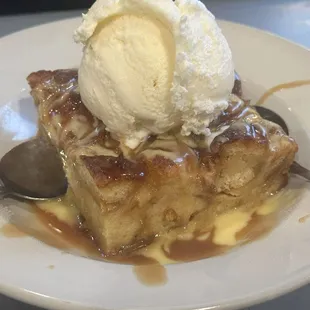 Bread pudding with a scope of vanilla ice cream.