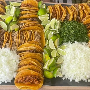 a platter of tacos and rice