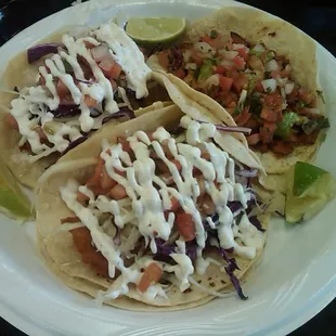 2 Fish Tacos w/ cabbage, pico de gallo, and a sauce that resembles ranch with a lil cilantro. Also pictured a Pastor taco. $7