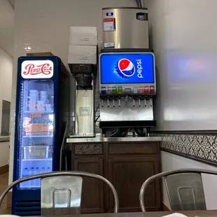 a soda machine and a soda cooler