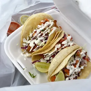 three tacos in a styrofoam container