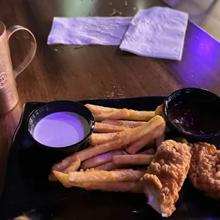 a plate of fried chicken strips and dipping sauce