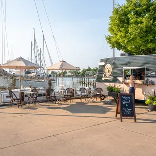 a woman standing in front of a food truck