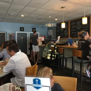 people sitting at tables in a restaurant
