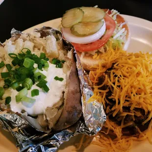 Cheeseburger and Baked Potato with Butter, Sour Cream, and Green Onions