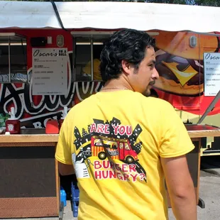 a man standing in front of a food truck
