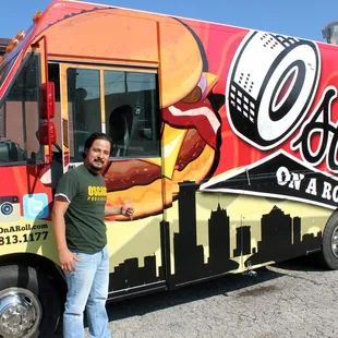 a man standing in front of a food truck