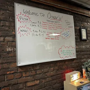 a whiteboard on a brick wall