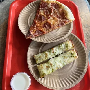 Slice of pepperoni pizza and Jalapeño breadsticks.