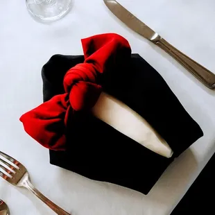 a red bow tie on a black napkin