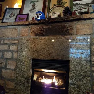 a fireplace with pictures on the mantle