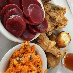 Fried chicken with pickled beets, carrot-raisin salad and hush puppies