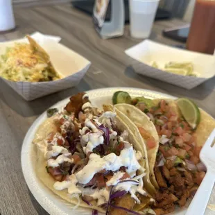 Shredded beef taco in back. Pastor and fish in front