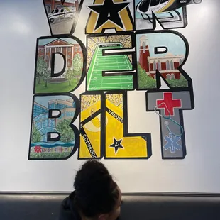 Wall on the left when you enter.