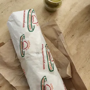 a sandwich wrapped in paper