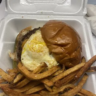 MKE Burger - beef patty, fried egg, fries pickle, fried cheese curds, and melted sharp cheddar cheese.