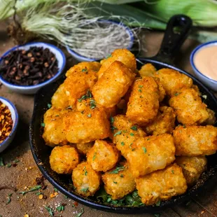 a bowl of tater tots and other ingredients