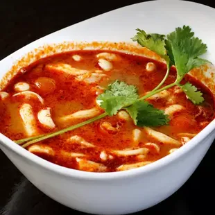 Tom Yum Spicy and sour soup, lemongrass, galangal, kaffir lime leaf, mushroom, and tomatoes.  Choose size Cup or Bowl