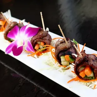 Beef Wasabi Rolls: Carrot, celery, and mint wrapped with grilled steak served with wasabi sauce