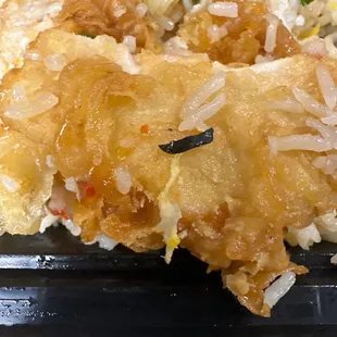 Black plastic object on the crispy chicken.