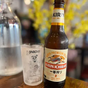 a beer bottle and a glass on a table
