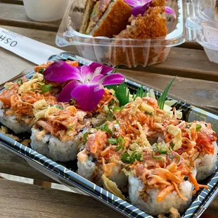 a plate of sushi and a plate of fried shrimp