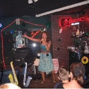 a woman singing on stage