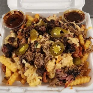 Maxed out fries xtra large fries topped with mac, chili, cheese, choice of meat &amp; jalapeños.