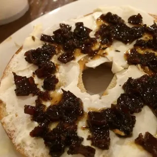 Bagel with cream cheese and bacon jam for breakfast