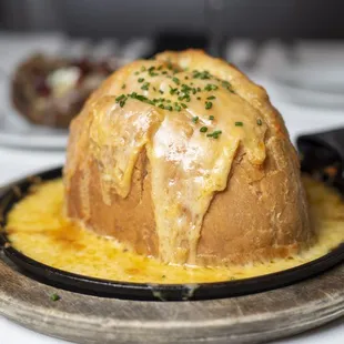 a baked potato with cheese and chives