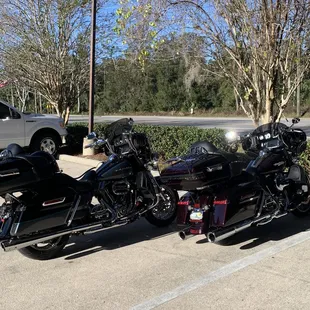 two motorcycles parked in a parking lot