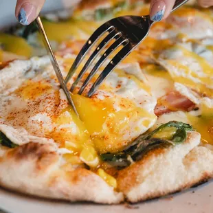 Brunch Benedict Pizza: 2 fried eggs, pancetta, spinach, mozzarella, hollandaise sauce