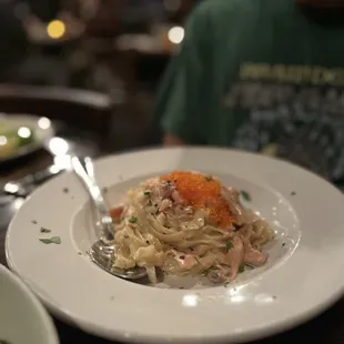 a plate of pasta with salmon